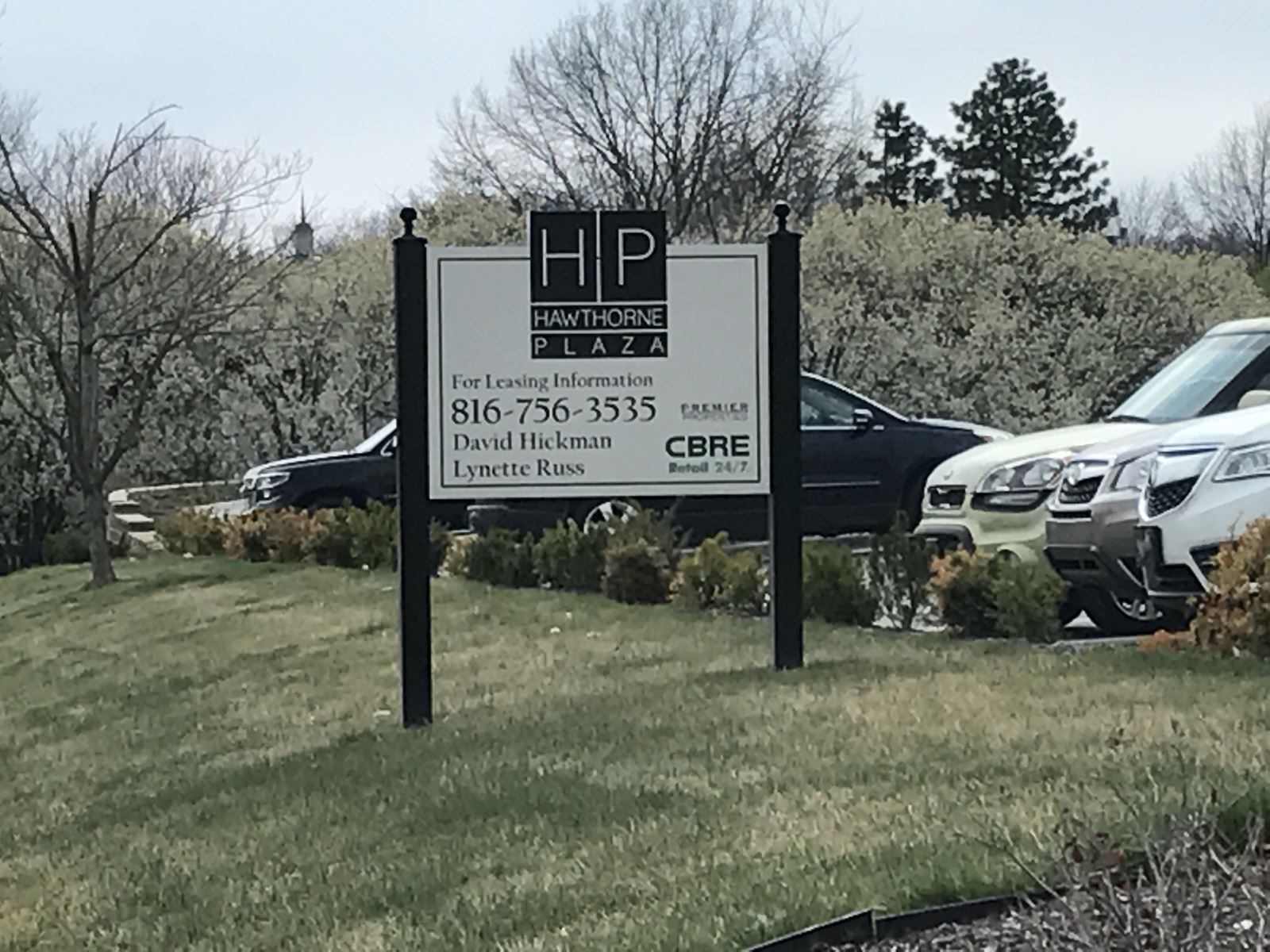 Photo of an incidental sign amongst a parking lot and landscape