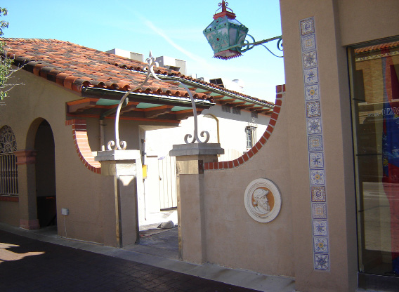 Front view of a house with a gate and a lamp