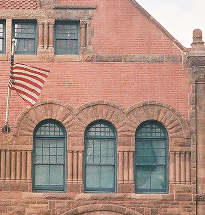 photo of brick building with arched windows 
