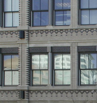 photo of stone and brick building with windows 