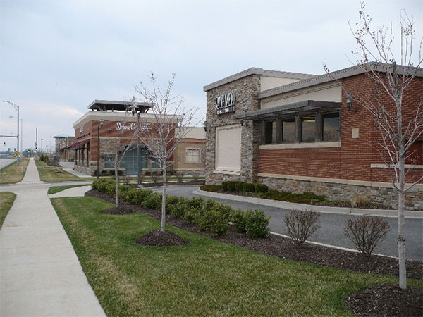 Photo of drive-through bays and stacking areas on a building with landscape around