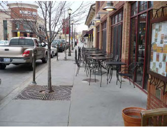 Photo of Shade trees landscaped around an outdoor patio on a commercial building 