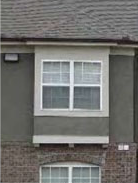 residential building with box bay window and arched window opening
