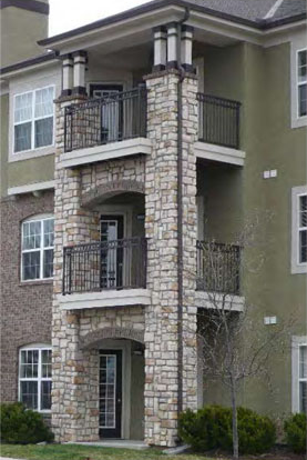 residential building with porches with arches, iron railings and columns 