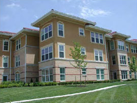 photo of residential building with stucco and stone materials 