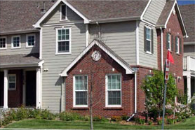 photo of residential building with siding and brick materials 