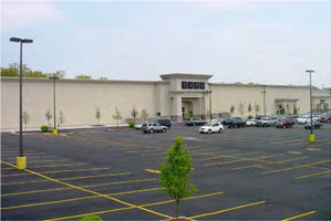 drawing of the front walls of a commercial building with few features to break up its length