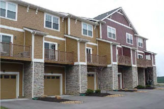 photo of residential building with garage doors 