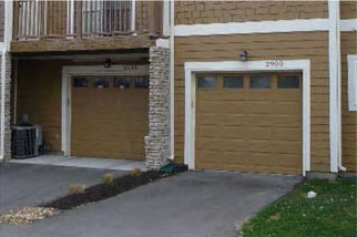 photo of residential building with garage doors 