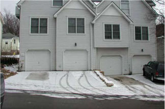 photo of residential building with garage doors 