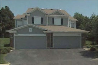 photo of residential building with garage doors 
