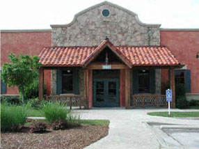 photo of an entrance of a commercial building with downspouts located on the interior corners 