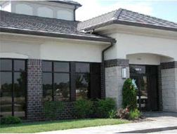 photo of an entrance of a commercial building with downspouts located on the interior corners 
