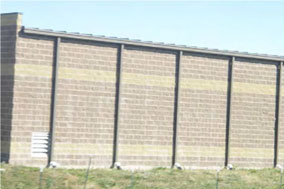 photo of the exterior of a building with a flat roof and exposed gutters