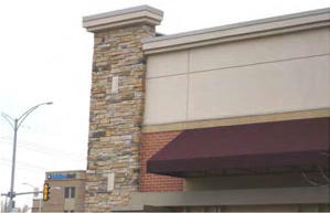 photo of a building with different types of stone and stucco materials 