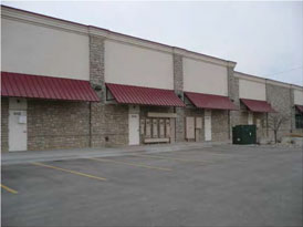 photo of a building with a plain facade and awnings