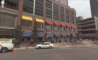 photo of parking garage above retail and office buildings