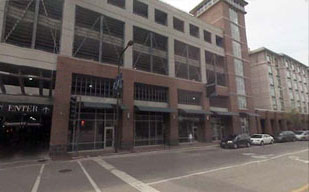 photo of multiple story parking garage above retail and office buildings