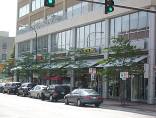 photo of parking garage above retail and office buildings