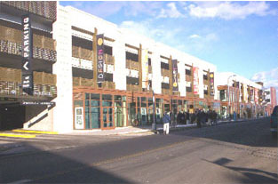 photo of parking garage above retail and office buildings