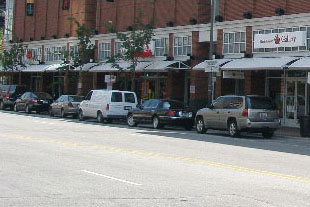photo of parking garage above retail and office buildings