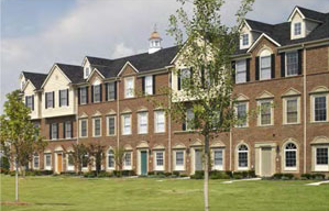 photo of a residential building with a continuous roof with dormers and cupolas