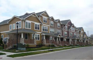 photo of a residential building with a long roof broken up with gables