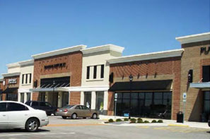 photo of multiple attached commercial buildings with brick and stucco