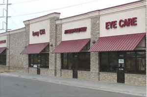 photo of multiple attached commercial buildings with brick and stucco
