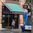 photo of sign attached to an awning on a commercial building 