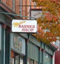 photo of sign hanging from side of commercial building 