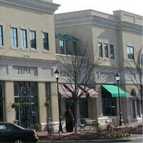 photo of a horizontal signage attached to multiple commercial building structures