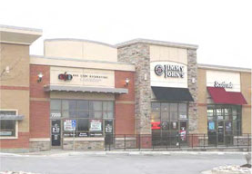 photo of a horizontal signage attached to multiple commercial building structures