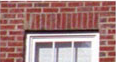 Close-up of a soldier course brick pattern installed above a window opening