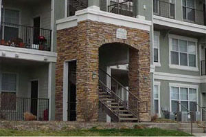 photo of a residential building with a front entrance with columns and archway