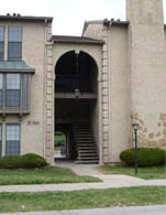 photo of a residential building with an arched front entrance taller than one-story