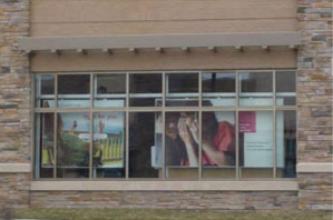 photo of commercial building with a stone wall and window frame 